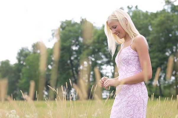 Blonde woman walking in a field uid 1284856.jpg