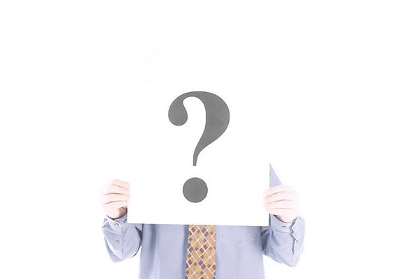 Businessman holding up white sign with question mark.jpg