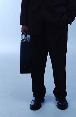 Businessman in black suit with briefcase.jpg
