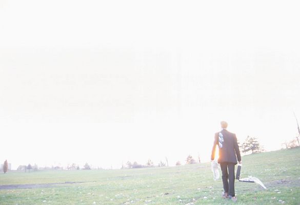 Businessman standing in field with open briefcase 3.jpg
