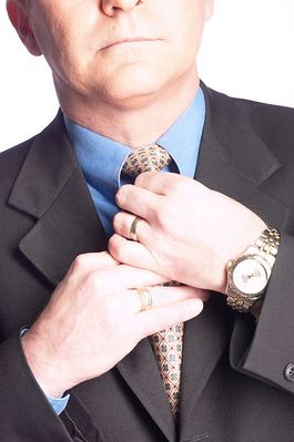 Businessman straightening his tie 1.jpg