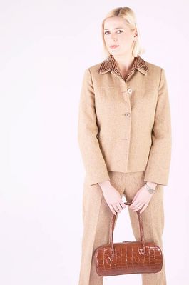 Businesswoman in brown suit with brown leather purse.jpg