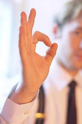 Caucasian businessman giving okay sign.jpg