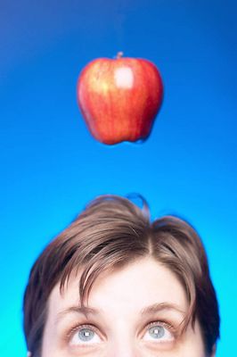 Caucasian woman face with apple hanging over her head against 3.jpg