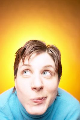 Caucasian woman smirking against yellow background.jpg