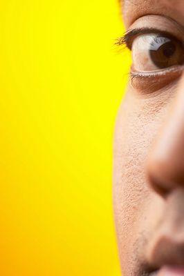 Close up of half of South Asian man face against yellow backgr 1.jpg