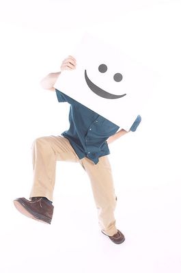 Man running with smiling face on white sign over his face.jpg