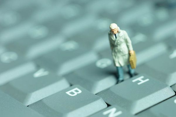 Model of businessman standing on keyboard.jpg