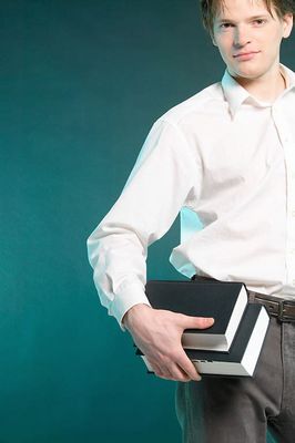 Passive male adult holding books uid 1453424.jpg