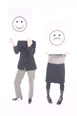 People holding up happy and sad face signs 1.jpg