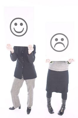 People holding up happy and sad face signs.jpg