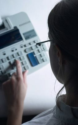 Profile of Caucasian businesswoman with using calculator.jpg