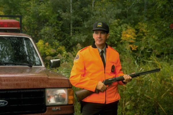 Ranger in orange jacket with gun.jpg