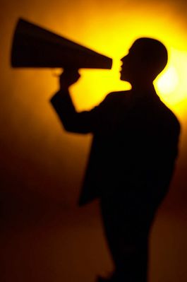 Silhouette of man yelling into a bullhorn.jpg