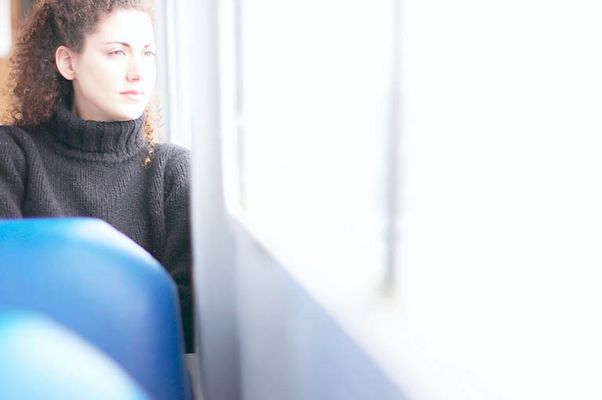 Woman looking out bus window uid 1283668.jpg
