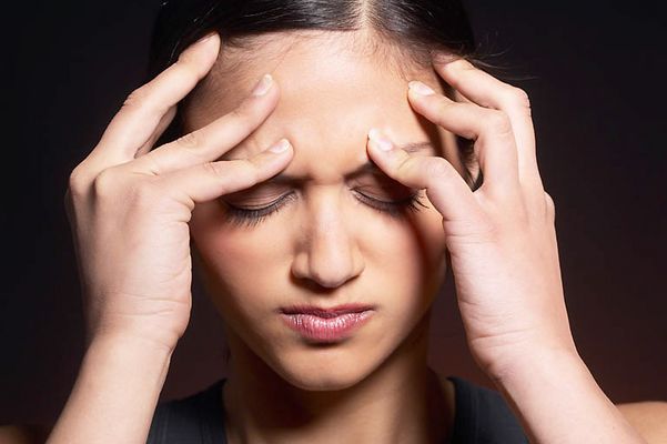 Woman massaging forehead uid 1426316.jpg