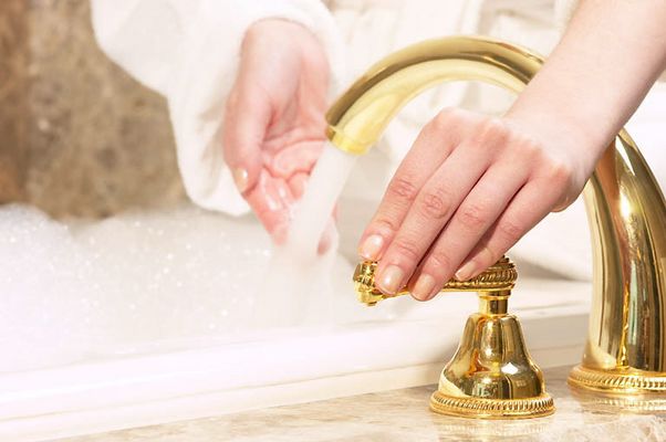 Woman testing bath water temperature 1.jpg