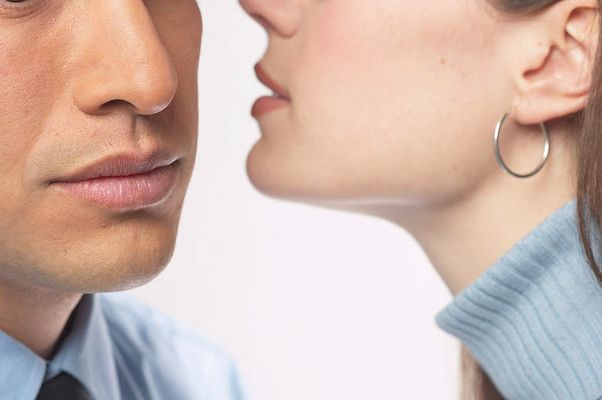 Woman whispering secret into man ear 3.jpg