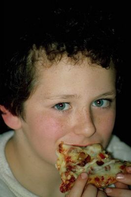 Young boy eating pizza.jpg