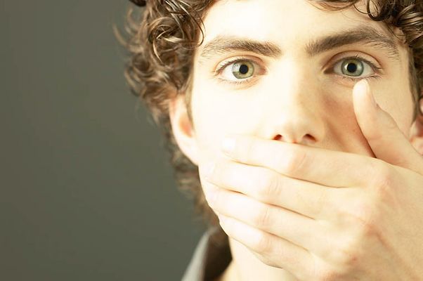 Young man covering his mouth.jpg