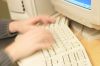 Blur of Caucasian man typing on computer keyboard.jpg