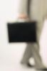 Blur of businessman walking with briefcase.jpg