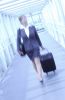 Blur of businesswoman pulling suitcase uid 1284388.jpg