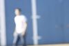 Blur of person walking past blue and white barn.jpg