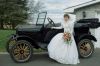 Bride standing next to 1920 car.jpg