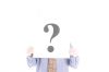 Businessman holding up white sign with question mark.jpg