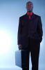 Businessman in black suit holding briefcase.jpg