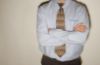 Businessman in tie leaning against wall 1.jpg