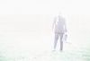 Businessman standing in field with open briefcase 1.jpg