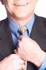 Businessman straightening his tie.jpg