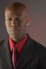 Businessman wearing red shirt and tie under black suit c102979.jpg