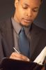 Businessman writing in day planner 101.jpg