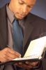 Businessman writing in day planner 2.jpg