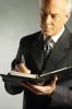 Businessman writing in day planner 5.jpg