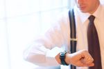 Caucasian businessman checking time on wristwatch.jpg