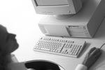Caucasian businesswoman operating mouse at desk in front of comp.jpg