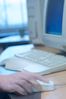 Caucasian man hand operating mouse on desk beside computer.jpg