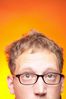Caucasian man looking straight ahead orange background.jpg