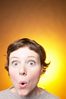 Caucasian woman expressing surprise yellow background.jpg