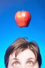Caucasian woman face with apple hanging over her head against 3.jpg