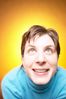 Caucasian woman smiling and looking upwards against yellow backg.jpg