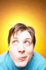 Caucasian woman smirking against yellow background.jpg