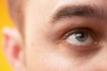 Close up of Caucasian man looking upwards against yellow backgro.jpg