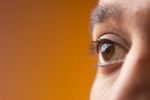 Close up of South Asian man brown eyes against orange backgrou 1.jpg