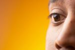 Close up of South Asian man brown eyes against orange backgrou 2.jpg