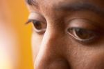 Close up of South Asian man brown eyes against orange backgrou 3.jpg